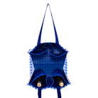 Blue tote bag with checkered lining holding two bottles on a white background