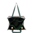 A dark green canvas tote bag with a multicolor floral print on the exterior and a solid dark green interior, shown from a top-down view on a white background.
