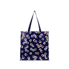 A navy blue tote bag with a repeating white, red, and yellow floral pattern, featuring two dark blue shoulder straps, shown against a plain white background.