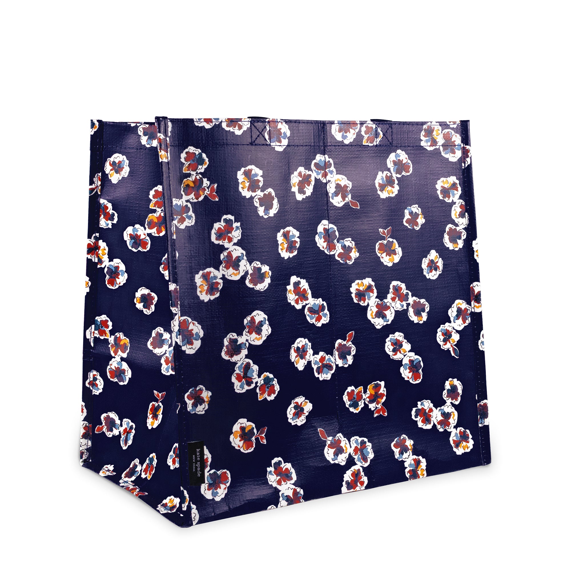 A shopping  bag with a dark navy blue background and an all-over floral pattern in white, orange, and red, shown on a plain white background.