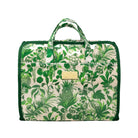 A green and white botanical print duffel bag with dark green trim, top handles, and a small gold-tone metal plaque on the front.
