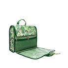 A green and white tropical print picnic blanket bag with a handle, shown with its matching zippered picnic cloth laid open underneath on a white background.
