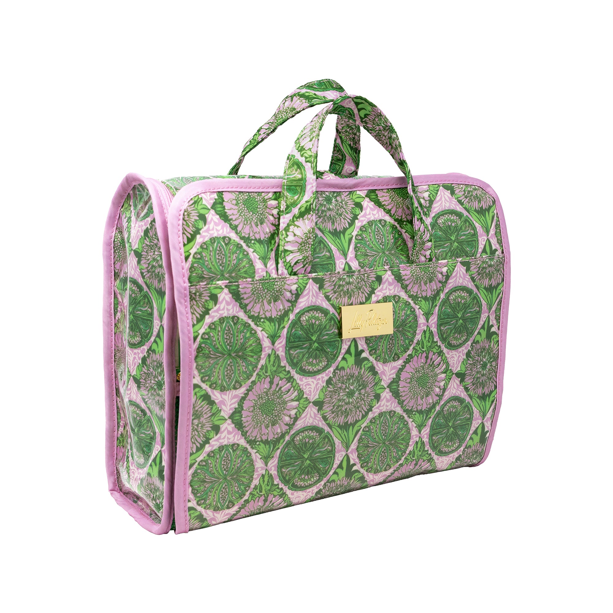 A rectangular zippered travel or toiletry bag with a green and pink botanical pattern, featuring pink trim, dual top handles, and a small gold metal brand plaque on the front.