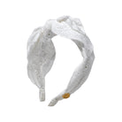 White lace headband with a bow on a white background