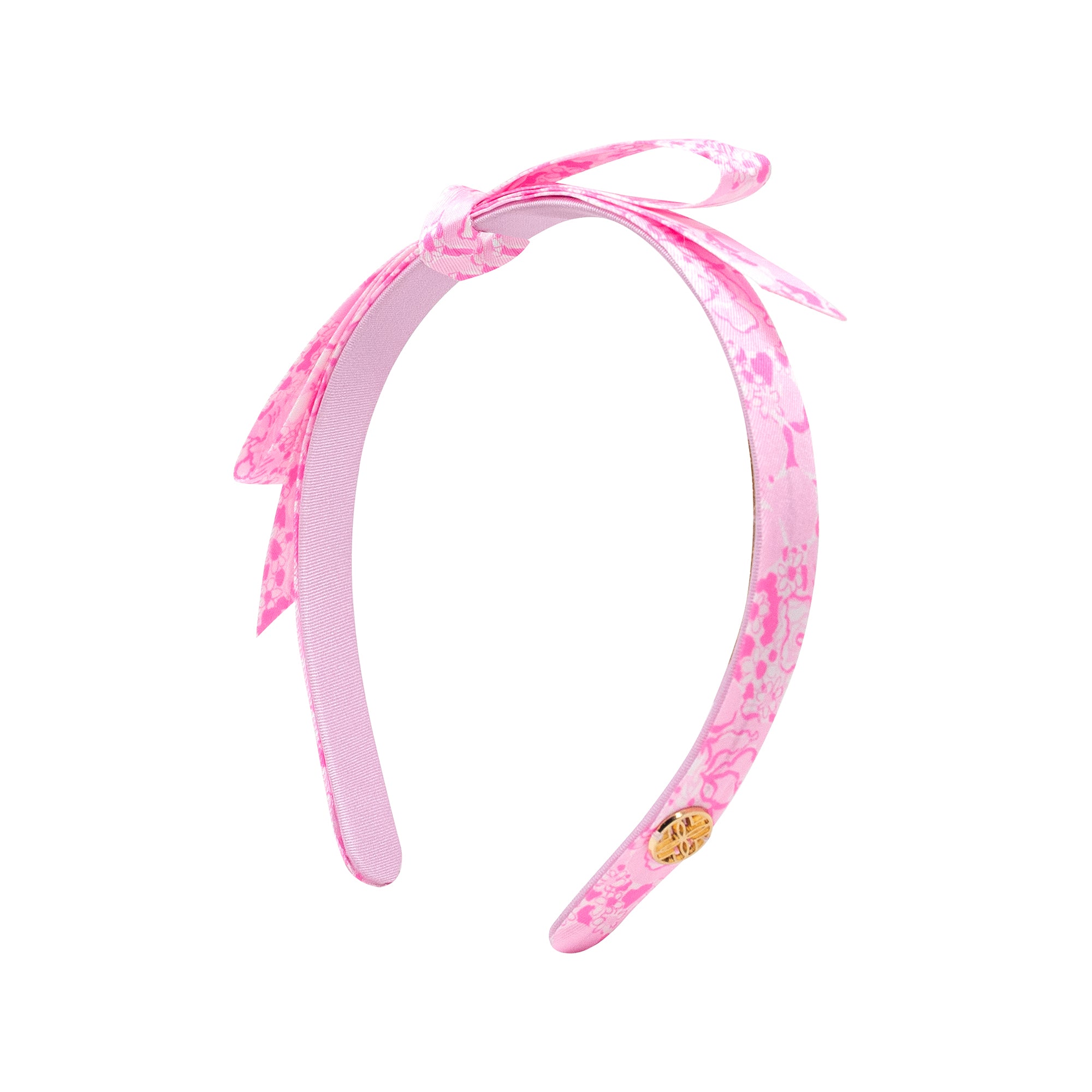 Pink headband with bow on a white background