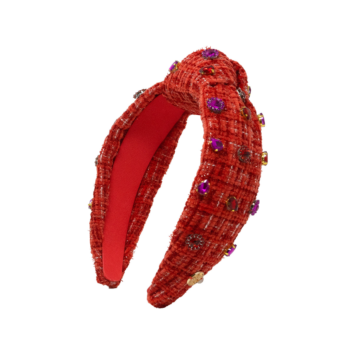 A red tweed headband with a twisted knot detail, decorated with purple and gold rhinestones, shown on a plain white background.