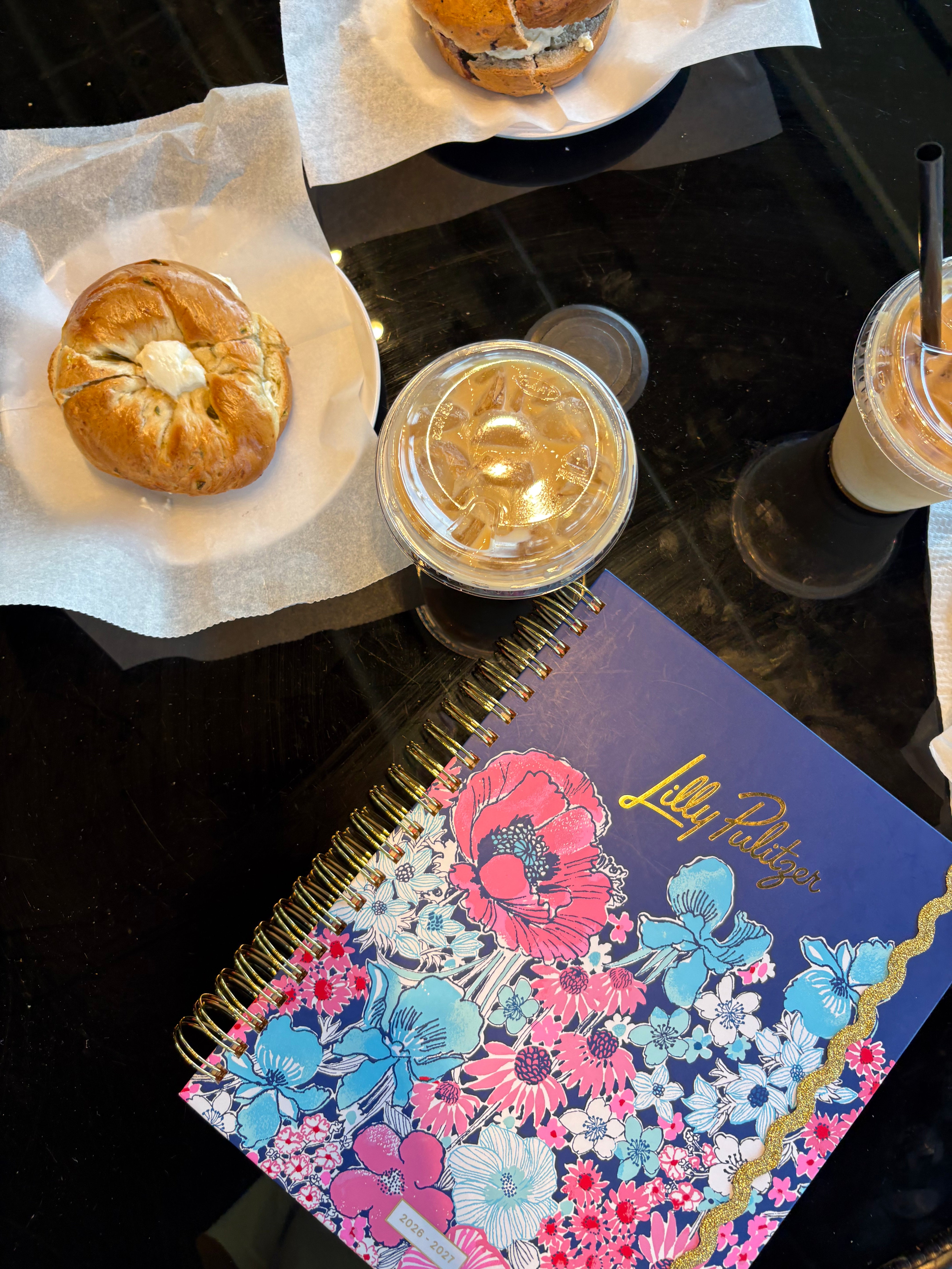 Floral notebook with 'Lilly Pulitzer' branding surrounded by baked goods