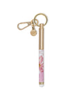 Gold pen with floral design and keychain on a white background