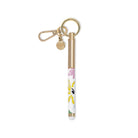 Gold pen with floral design and keychain on a white background