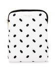 White pouch with black polka dot pattern and 'kate spade' branding on a white background