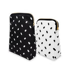 Two polka dot bags, one black with white dots and one white with black dots, on a white background.
