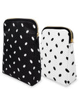 Two polka dot bags, one black with white dots and one white with black dots, on a white background.
