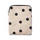 A Kate Spade canvas tablet sleeve featuring a black polka dot pattern on a light beige background, shown against a plain white studio background.