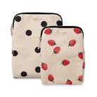 Two Kate Spade canvas zippered pouches on a white background. The larger pouch has a cream background with black polka dots, and the smaller pouch has a matching cream background with red strawberry prints.