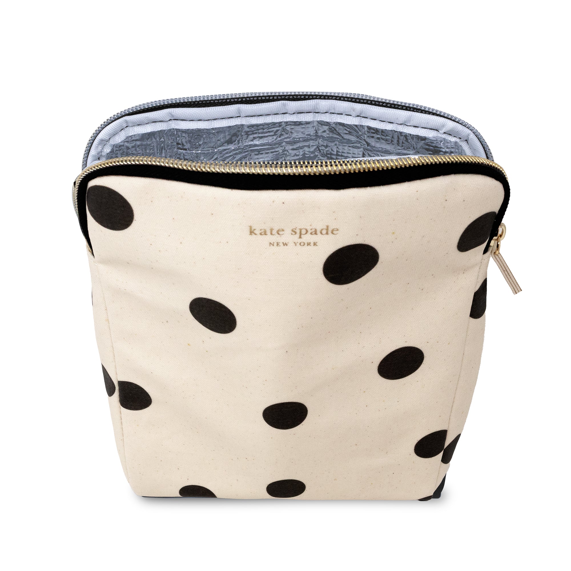 A Kate Spade New York cosmetic pouch in cream canvas with black polka dots, featuring a gold zipper and the brand's name printed in gold on the front.