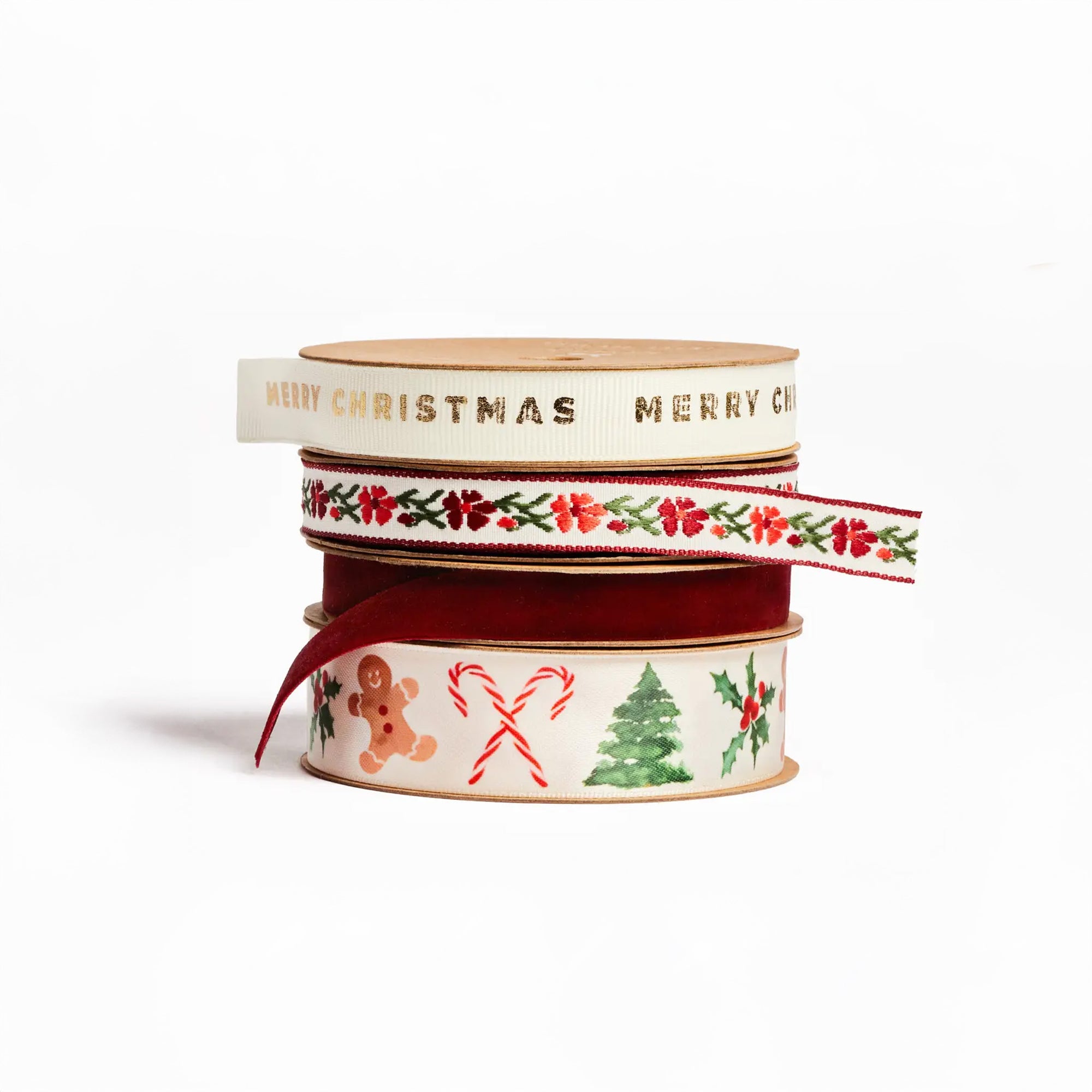4 rolls of holiday themed ribbon: Christmas Icons Satin Ribbon, Cream grosgrain ribbon printed with gold foil "Merry Christmas", Garnet burgundy velvet ribbon, Red vine floral woven ribbon 
