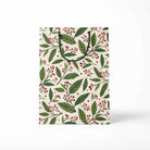 Gift bag with green leaf and red berry pattern on a white background