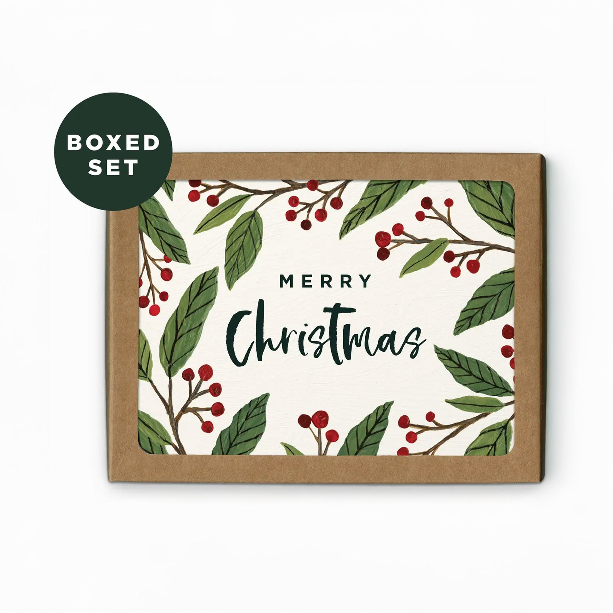 packaged Christmas card with green leaves and red berries and a brown envelope with 'Merry Christmas' on a white background