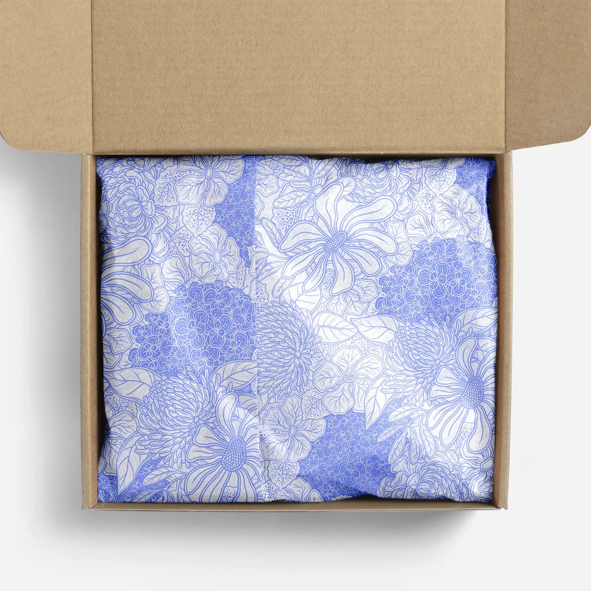 White and lavender floral tissue paper in a box