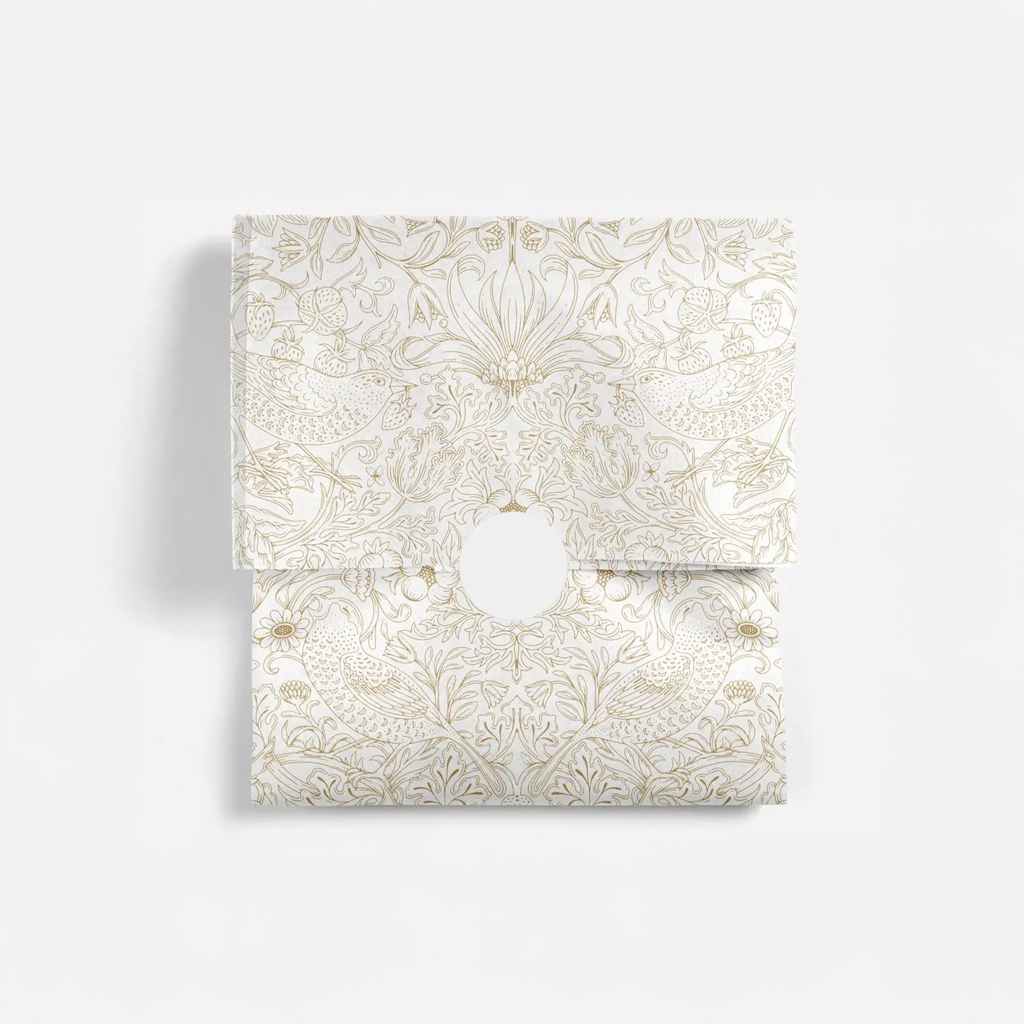 Decorative tissue paper with gold floral pattern on a white background