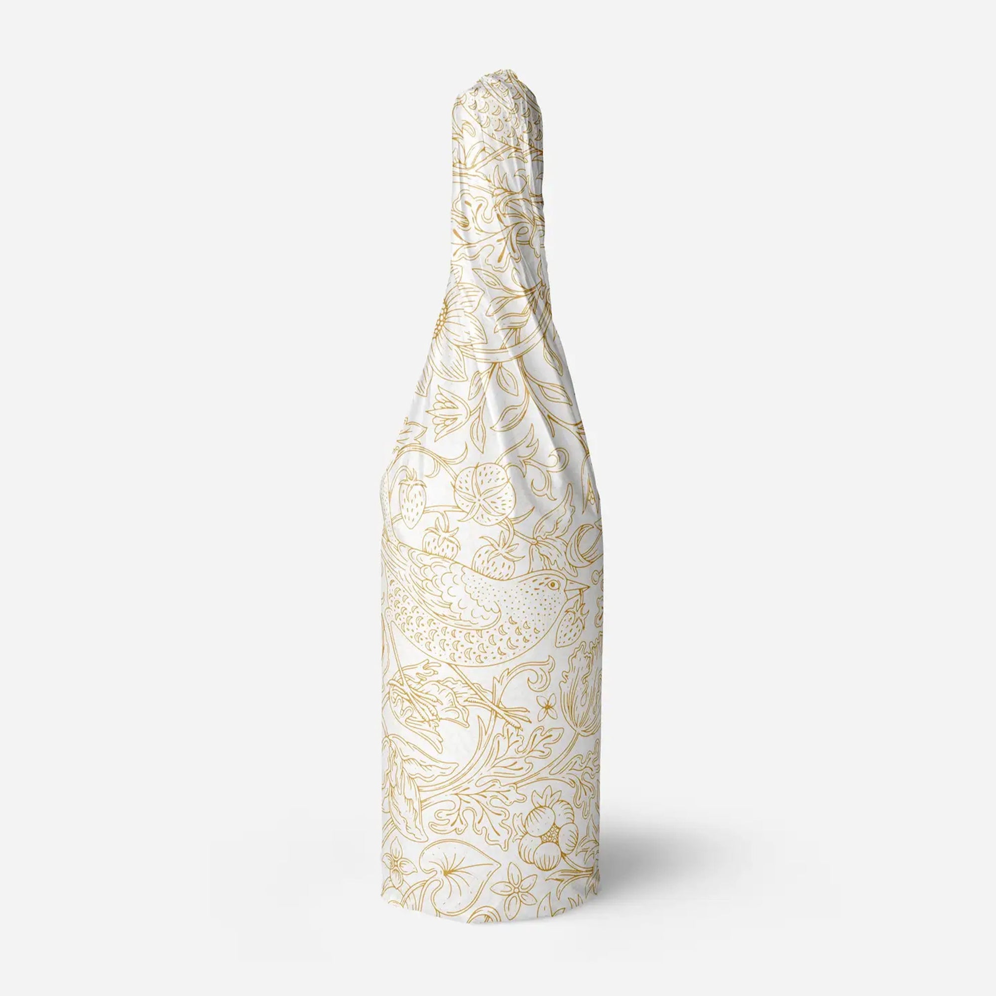 Decorative tissue paper with gold floral pattern wrapped around a bottle