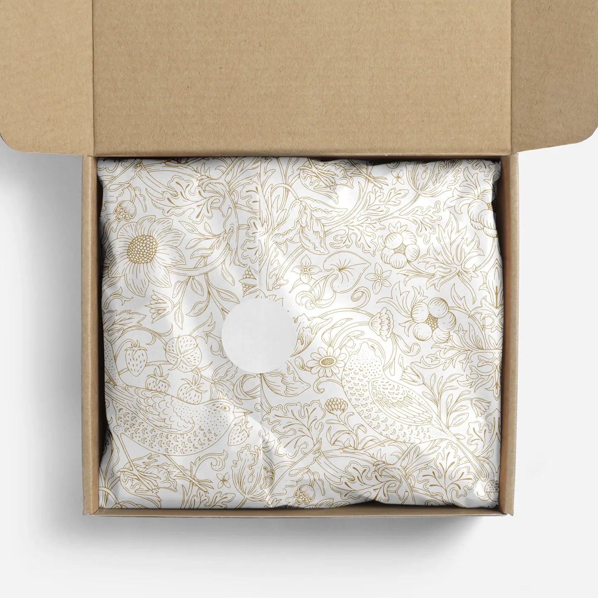 Decorative tissue paper with gold floral pattern in a box