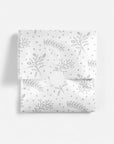 Silver floral patterned tissue paper on a white background