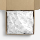 Silver floral patterned tissue paper in a box