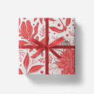 Gift box with red floral pattern and ribbon on a white background