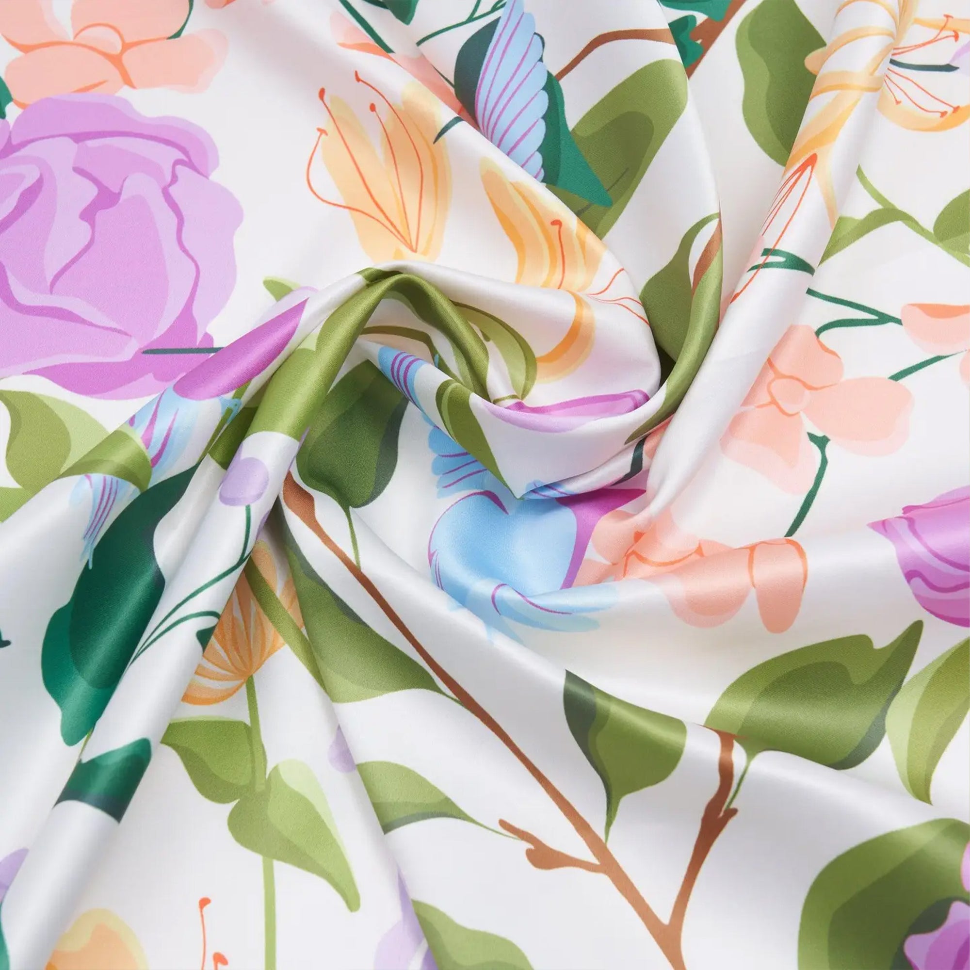 Floral fabric with colorful flowers and green leaves on a white background