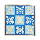 Square scarf with pixelated snowflake pattern in blue and white on a white background