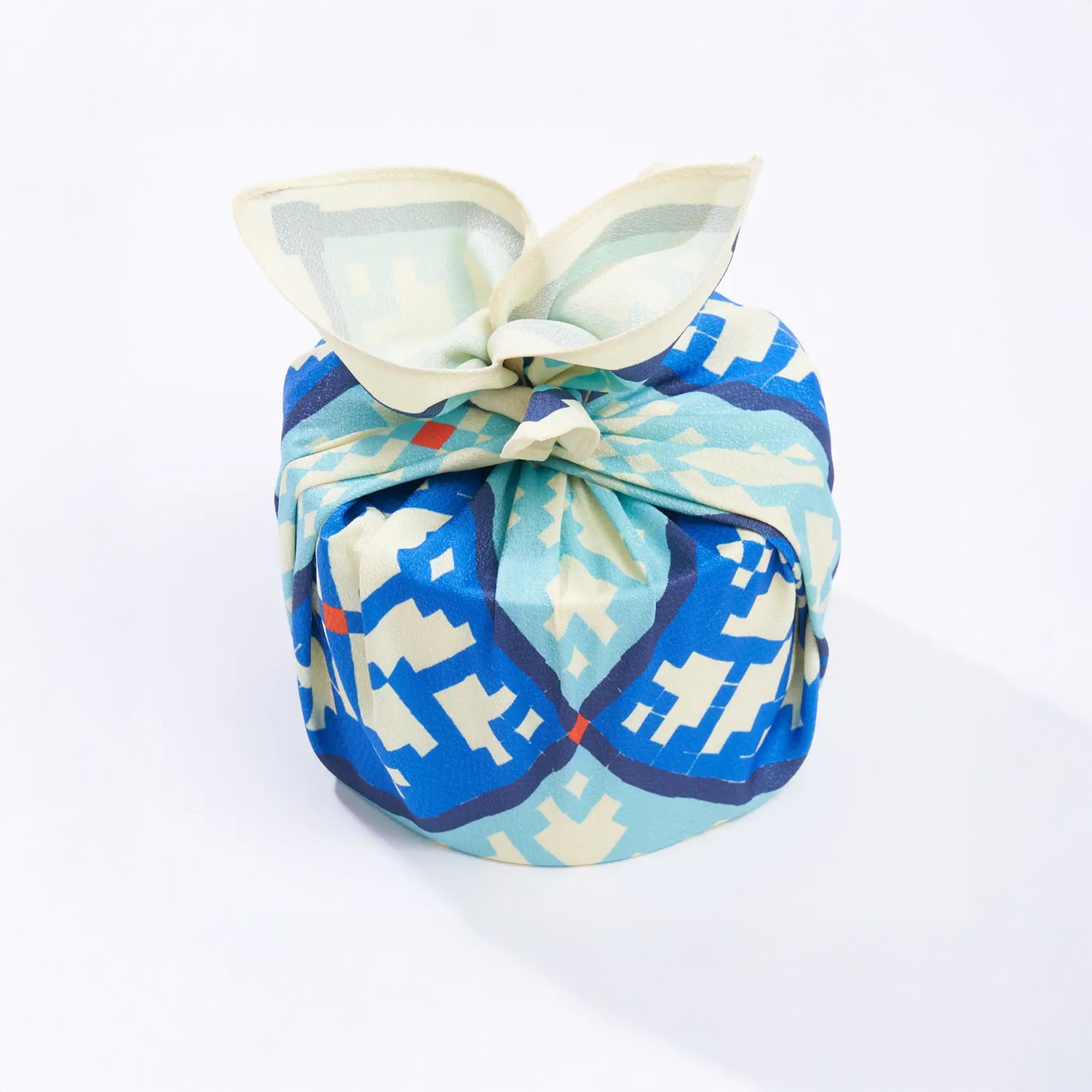 Patterned fabric bundle with a bow on a white background