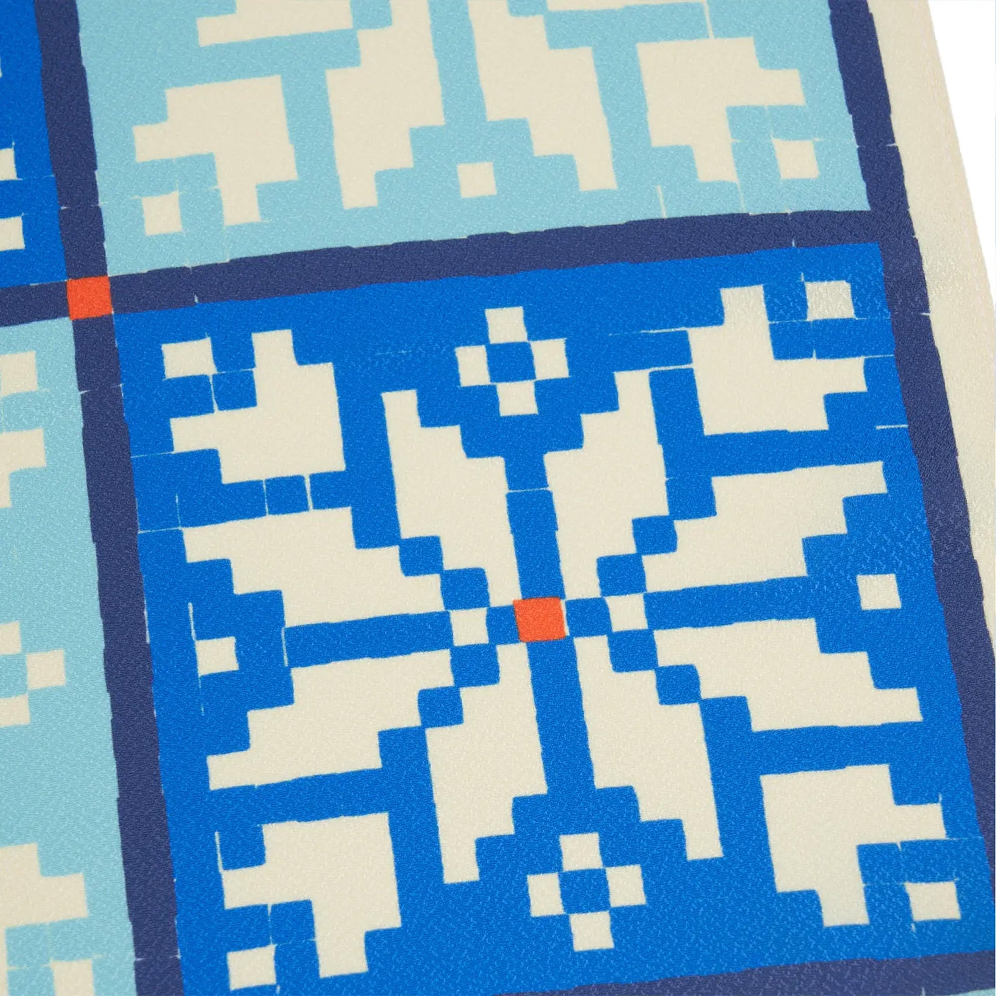 Close-up of a geometric patterned fabric with blue and beige colors.