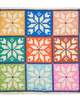 Colorful reusable gift wrap with geometric pattern on a white background