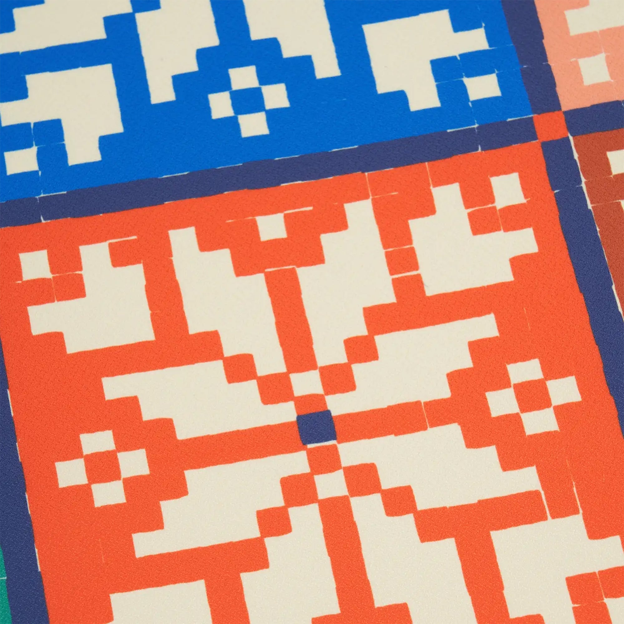 Close-up of a pixelated pattern with blue, red, and beige colors.