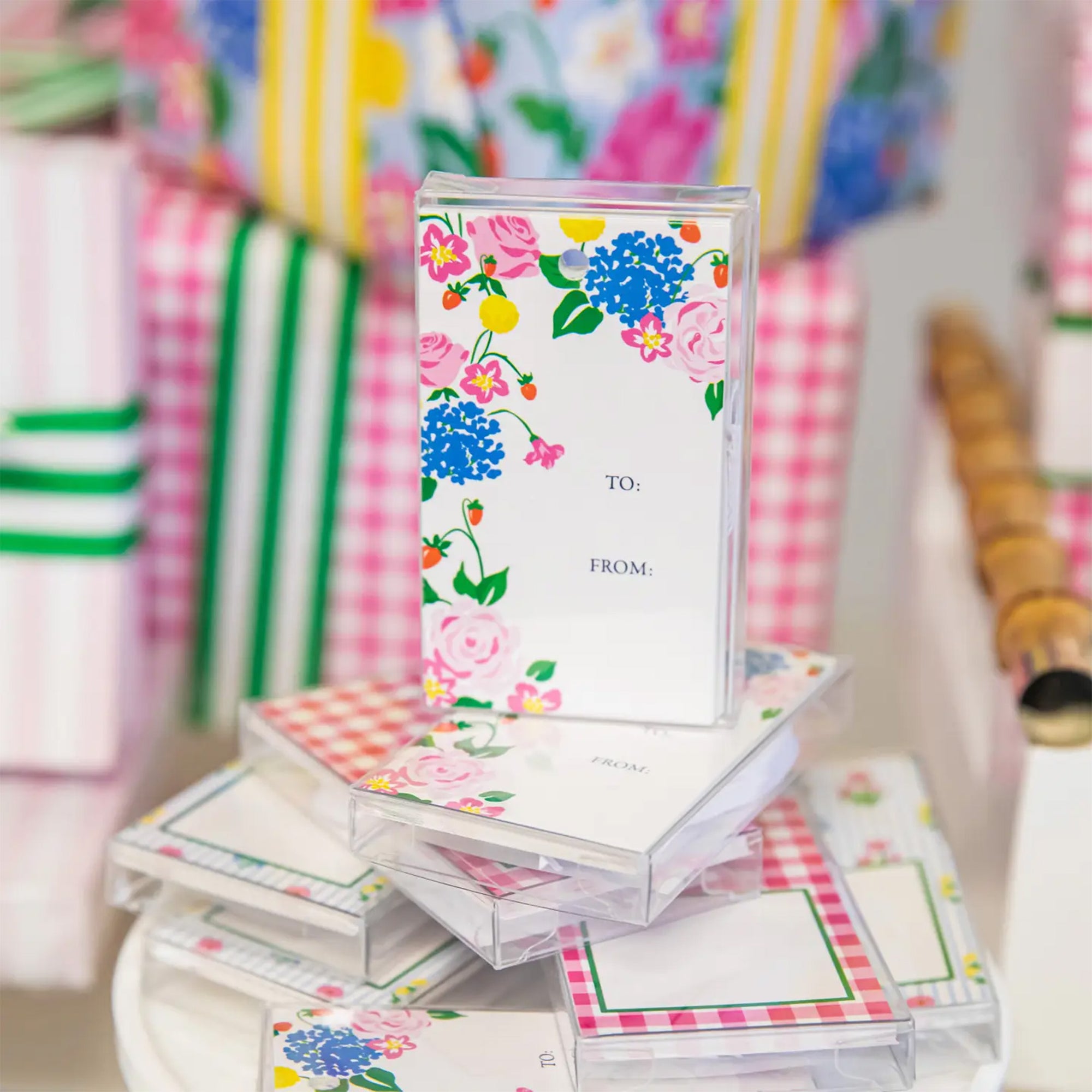 Stack of floral and checkered gift tags with a colorful background