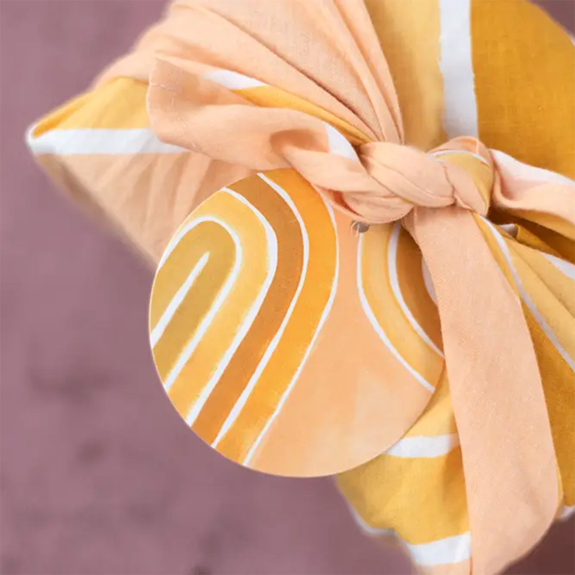 Yellow arch gift tags on a yellow wrapped gift