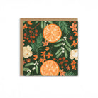 Greeting card with orange slices and floral design on a green background