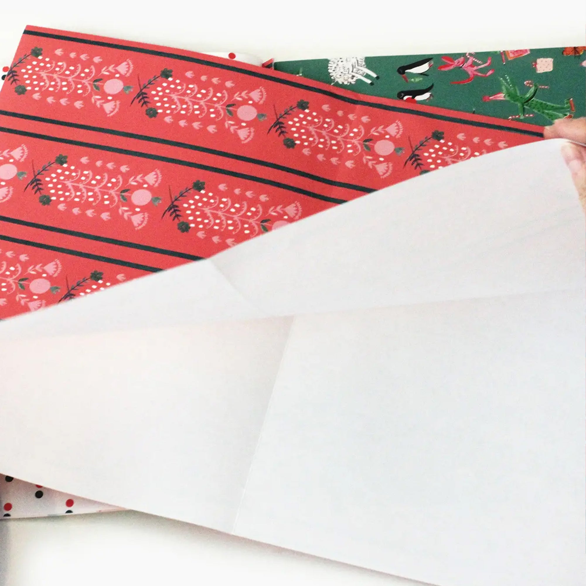 White paper with red and green patterned paper in the background