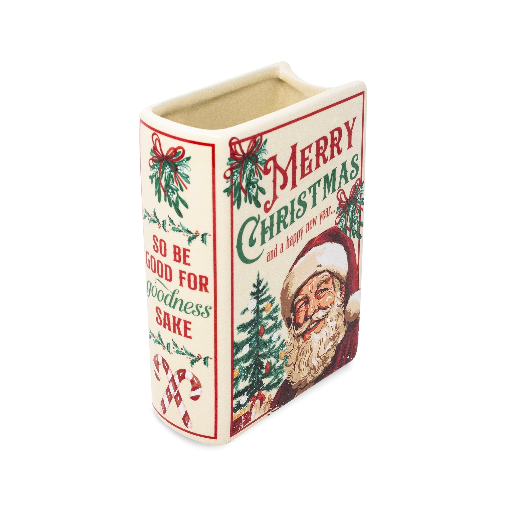 A vintage-style Christmas vase with a cream-colored body and festive red and green illustrations, including a Santa Claus face, holly, candy canes, and the text 'Merry Christmas' and 'So be good for goodness sake'.
