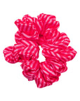 Pink and white striped scrunchie on a white background