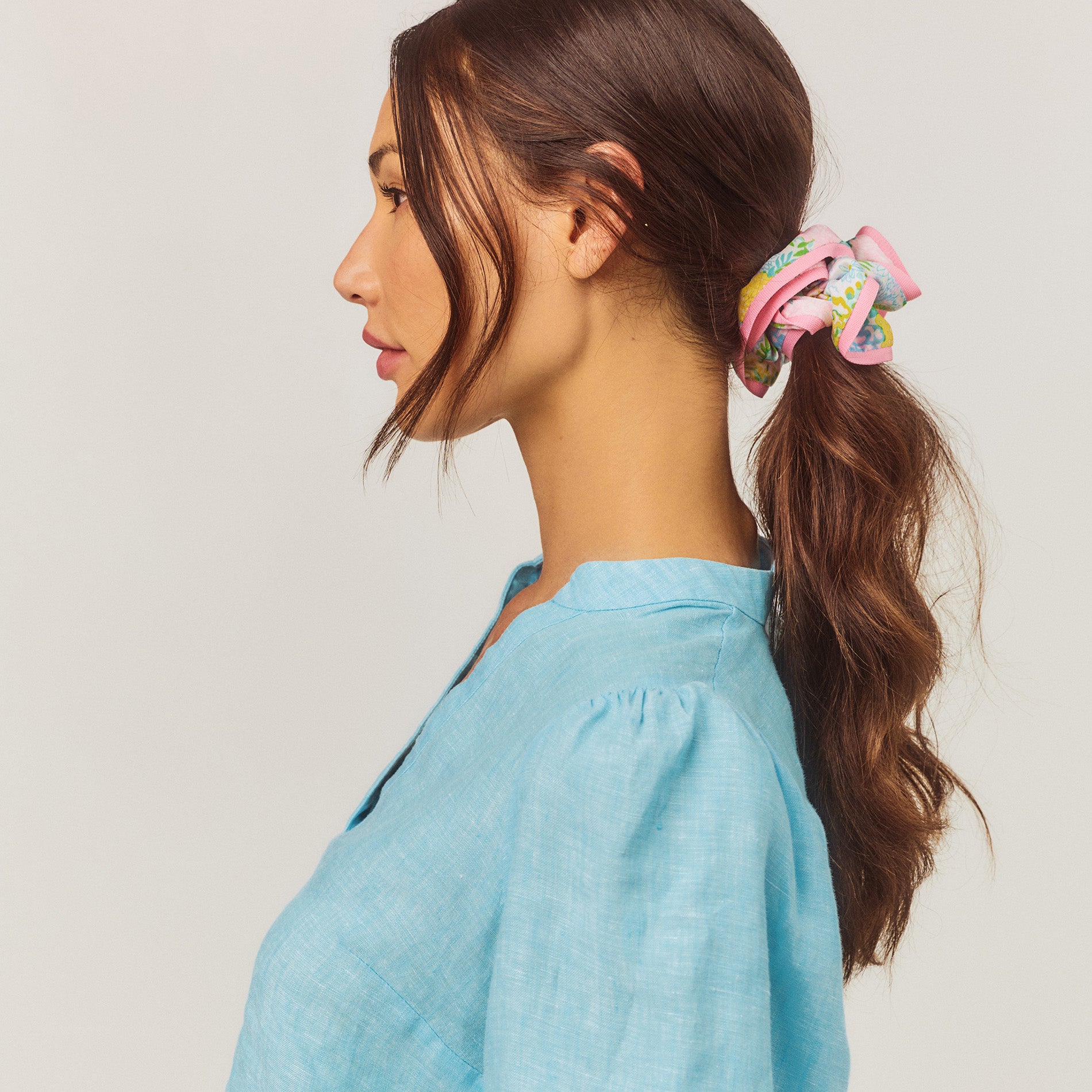 model wearing colorful hair scrunchie with pink trim