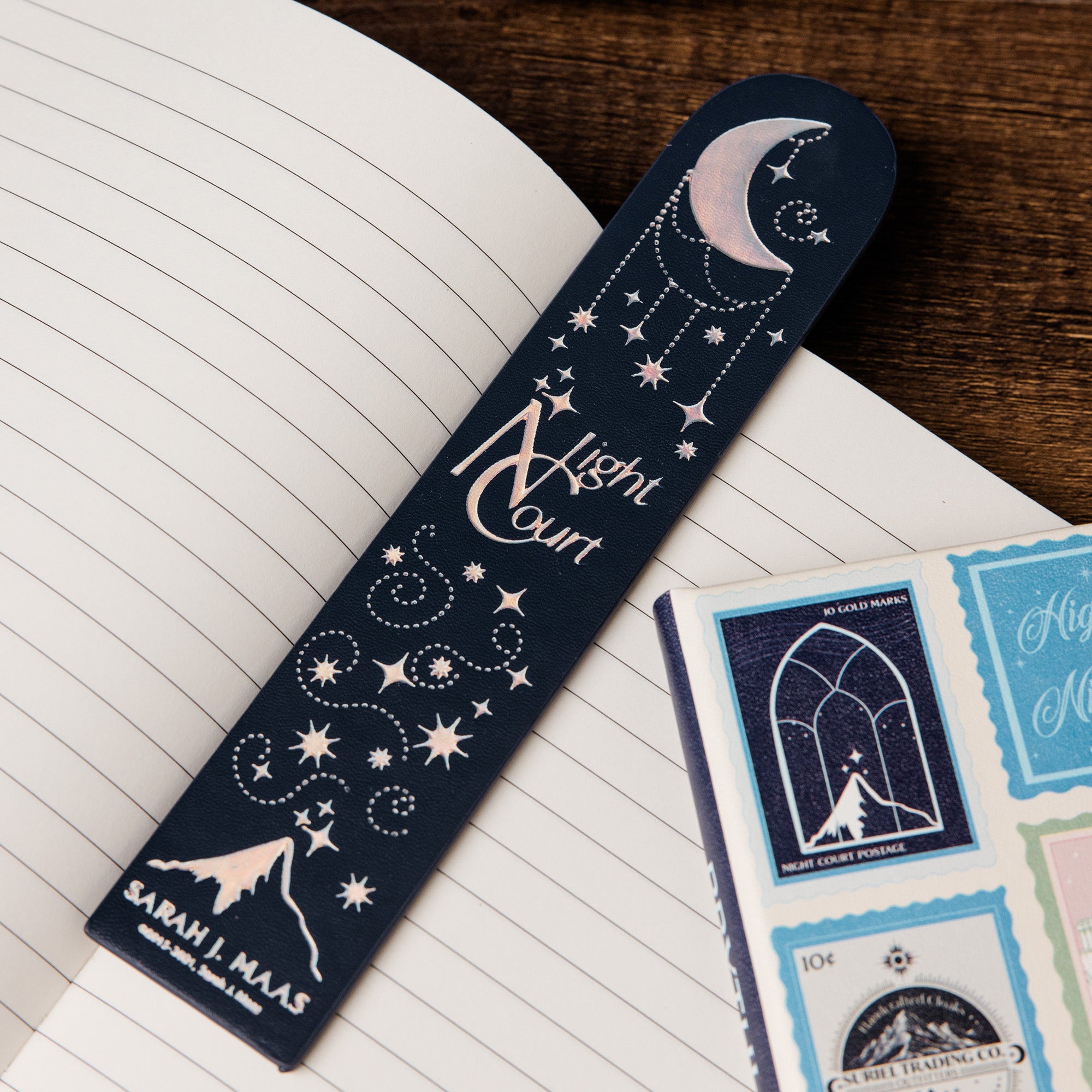 Navy bookmark with celestial design on an open book