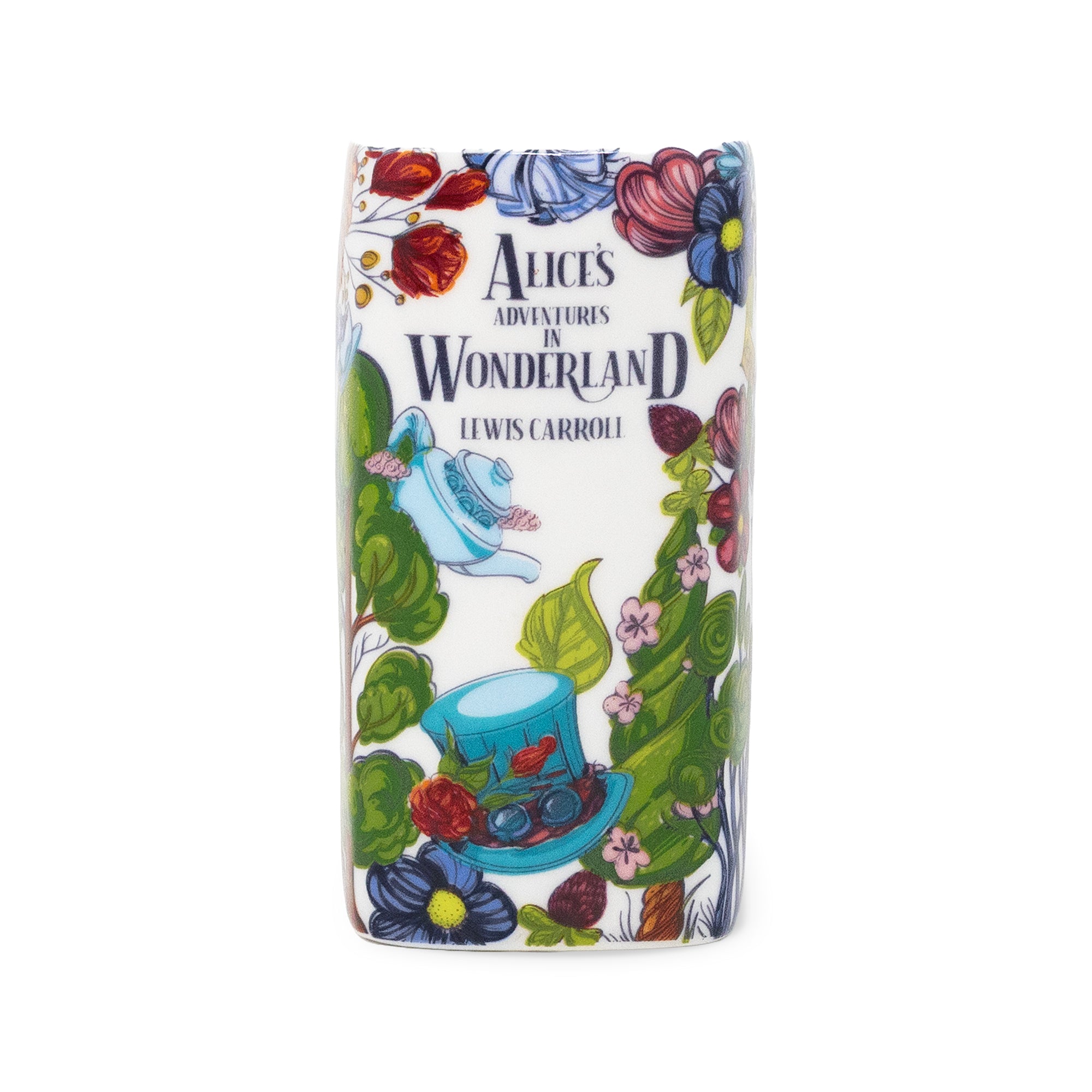 A book candle with rounded corners featuring an illustrated Alice in Wonderland design, including the text 'Alice's Adventures in Wonderland' and 'Lewis Carroll,' surrounded by flowers, leaves, a teapot, and a hat on a white background.
