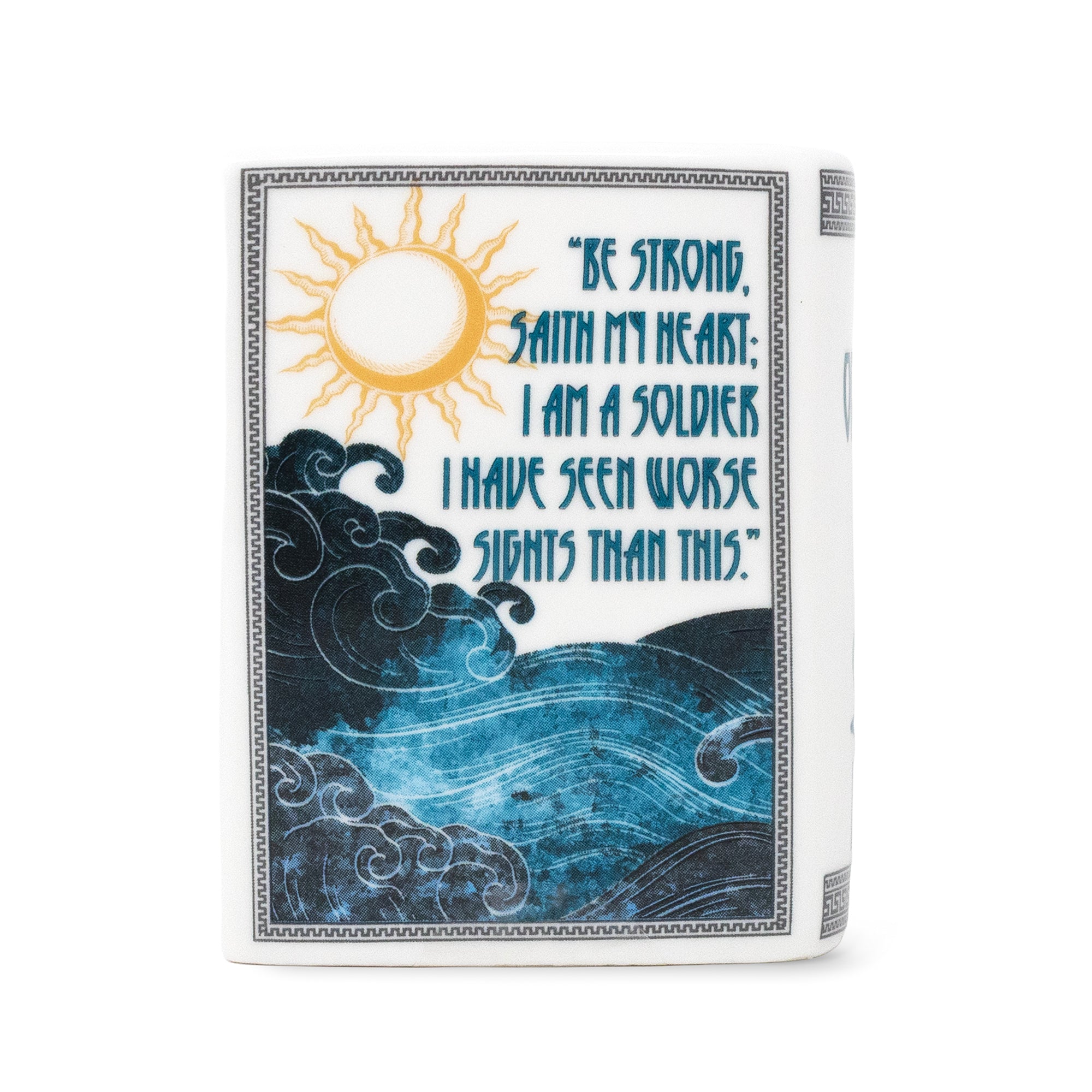 Ceramic candle with a printed cover design featuring a yellow sun, blue ocean waves, and a quote that reads, 'BE STRONG, SAITH MY HEART. I AM A SOLDIER.