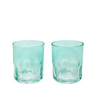 Two teal glass tumblers on a white background