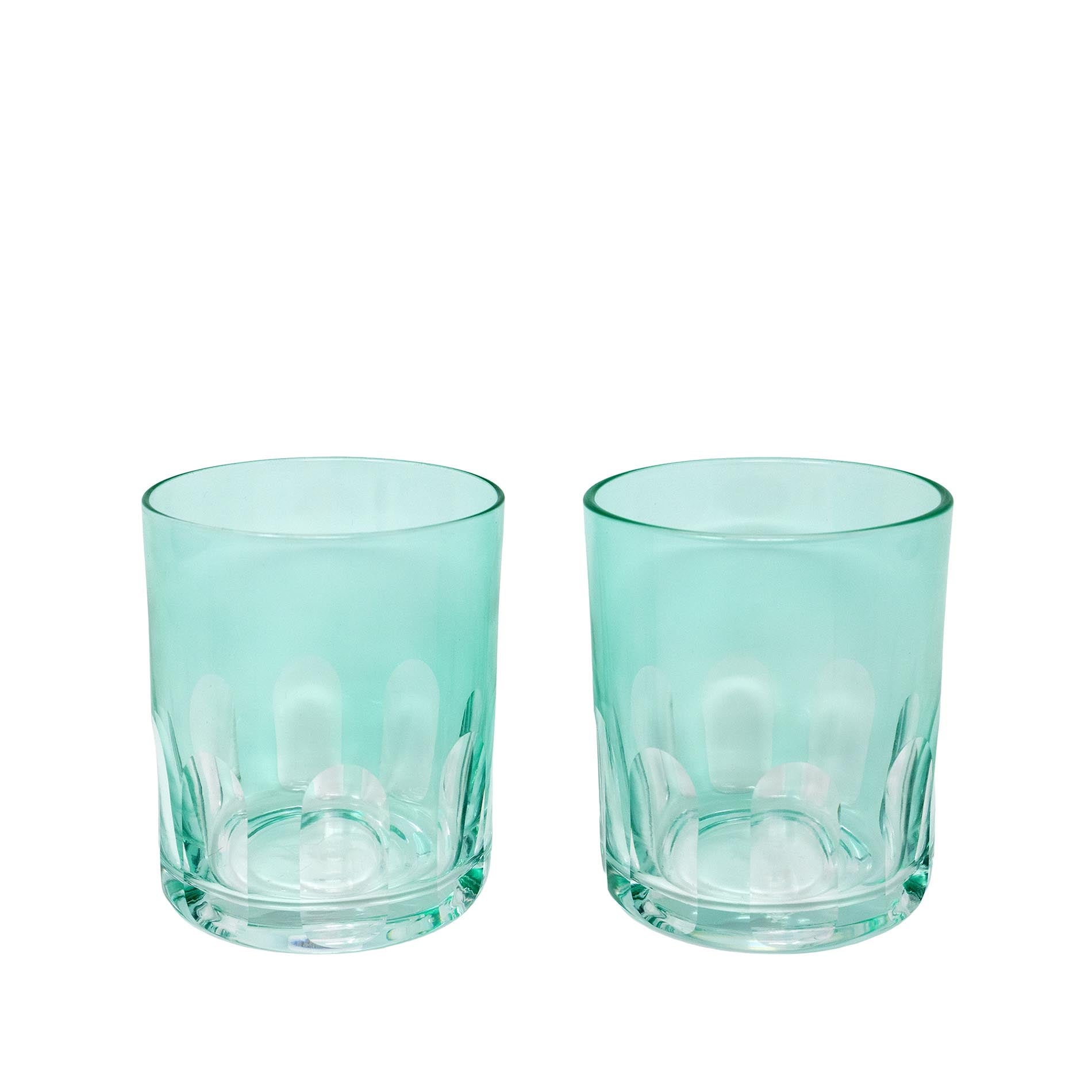 Two teal glass tumblers on a white background
