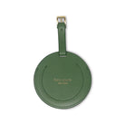 Green round luggage tag with 'kate spade New York' branding on a white background