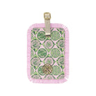 Luggage tag with green and pink pattern on a white background