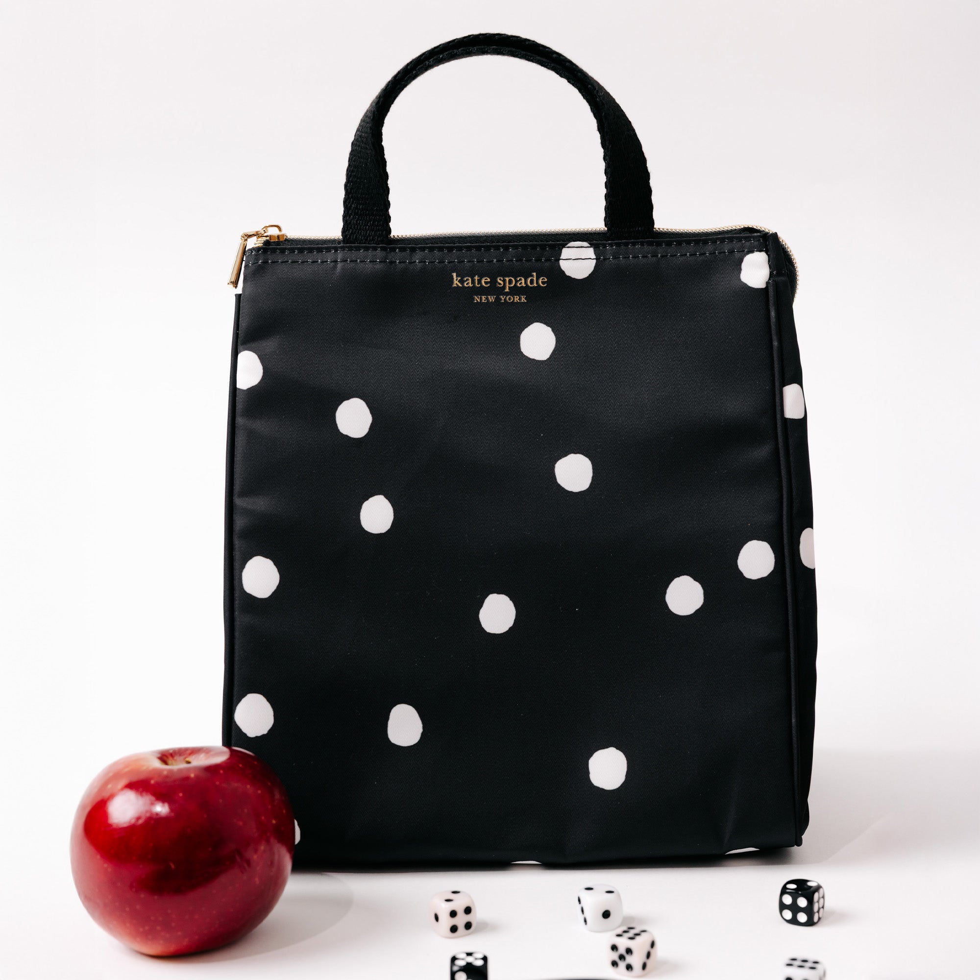 black lunch bag with white polka dots